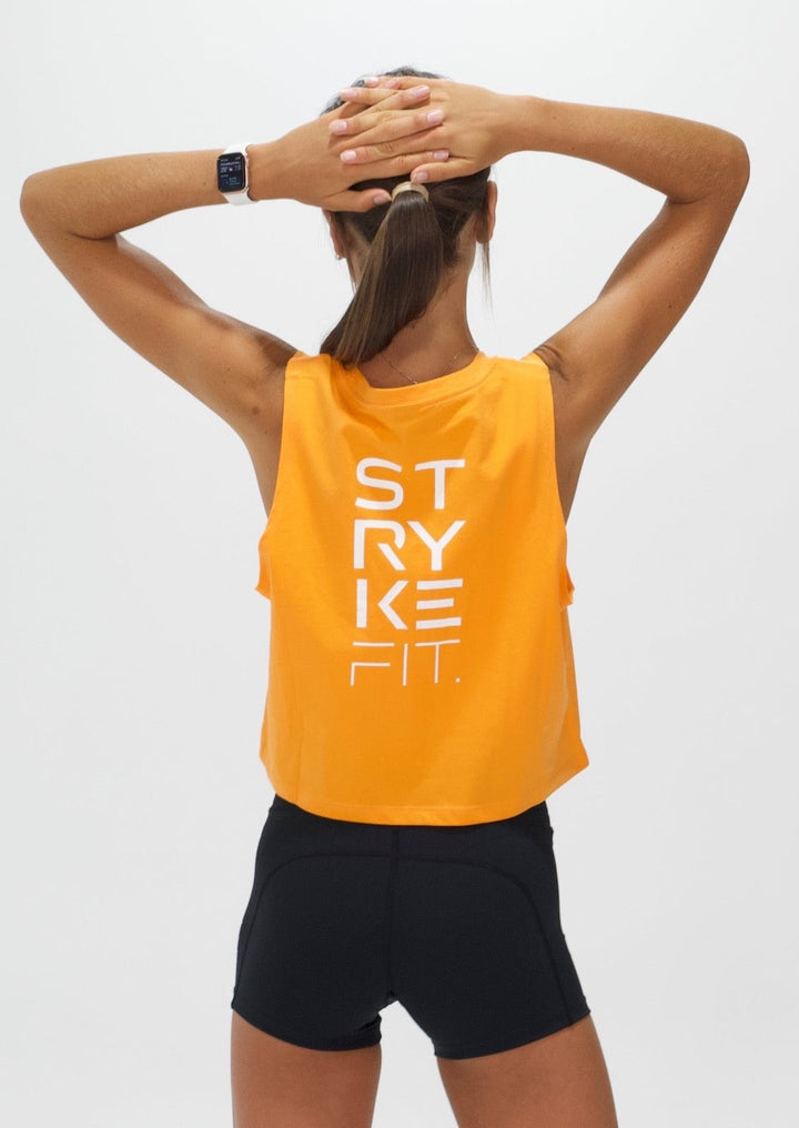 The TEAM CROP TANK is the perfect top for all your fitness needs. Featuring dropped armholes, a cropped length, and a relaxed fit. Whether you're going to the gym, for a walk or coffee you'll love this crop tee. The back view features a large print.