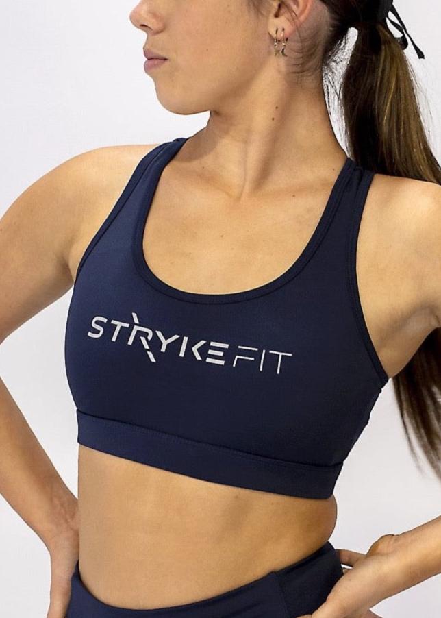 The STRYKE CROP TOP is designed with a back phone pocket enabling you to store your phone effortlessly while wearing, allowing you to listen to music, podcasts, or even just having your phone with you for personal security. The racerback straps follow the curve of your shoulder blades to allow your arms to move freely while offering maximum support. this Fuchsia pink Crop top with phone pocket is a must have this season.