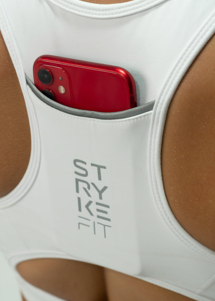 The STRYKE CROP TOP is designed with a back pocket enabling you to store your phone effortlessly, allowing you to listen to music, podcasts, or even just having it on you for personal security. The racerback straps follow the curve of your shoulder blades to allow your arms to move freely while offering maximum support.