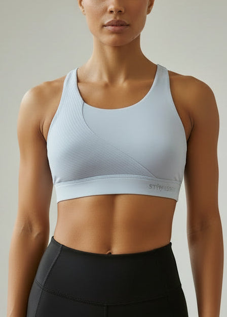 Woman wearing a light gray sports bra and black leggings on a neutral background. The ACTIVE CROP TOP is designed for runners who value freedom, comfort, and effortless performance.

Cross-over back straps follow the natural curve of your shoulder blades, allowing unrestricted arm movement and a natural feel through every stride. Lightweight and streamlined, this crop moves with you from warm-up to final sprint — so you can stay focused on the run.