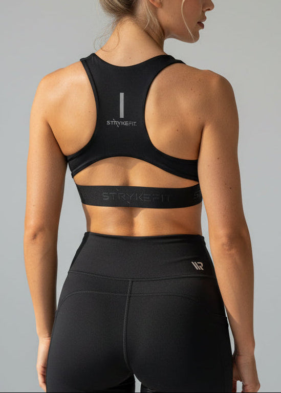 Woman wearing a black sports bra and shorts on a gray background.
The FIT 2.0 CROP TOP is a new version of our most popular style, this crop has a discreet back pocket to stash your phone, gels, or any running essentials.&nbsp;

The racerback design follows the natural line of your shoulders, unlocking full arm mobility while delivering uncompromising support. Lightweight, breathable, and made to move with you from the first step to the final sprint.