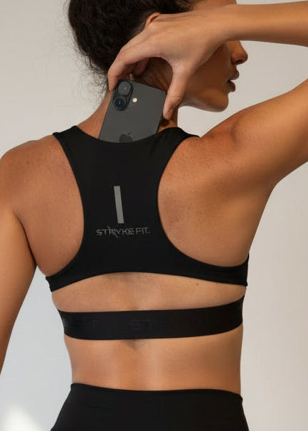 Woman wearing a black sports bra and shorts on a gray background.
The FIT 2.0 CROP TOP is a new version of our most popular style, this crop has a discreet back pocket to stash your phone, gels, or any running essentials.&nbsp;

The racerback design follows the natural line of your shoulders, unlocking full arm mobility while delivering uncompromising support. Lightweight, breathable, and made to move with you from the first step to the final sprint.