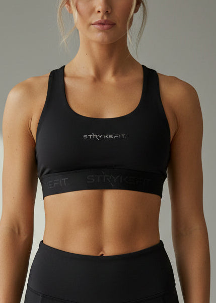 Woman wearing a black sports bra and shorts on a gray background.
The FIT 2.0 CROP TOP is a new version of our most popular style, this crop has a discreet back pocket to stash your phone, gels, or any running essentials.&nbsp;

The racerback design follows the natural line of your shoulders, unlocking full arm mobility while delivering uncompromising support. Lightweight, breathable, and made to move with you from the first step to the final sprint.