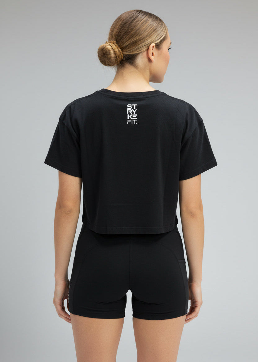 Woman wearing a black 'Stryke Fit' t-shirt and shorts on a gray background.
Your easy go to tee, done right.

The Focus Crop Tee is designed to pair effortlessly with all your Stryke activewear — perfect for gym sessions, or everyday wear.

Featuring a classic cropped silhouette and crafted from soft, breathable cotton, it delivers all-day comfort without feeling restrictive. Easy to style and even easier to wear, this is the piece you’ll reach for everytime.
