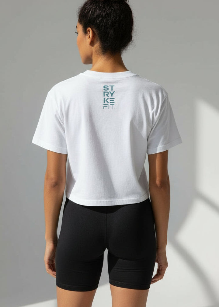 Woman wearing a white t-shirt and black shorts on a plain background
Your easy go to tee, done right.

The Focus Crop Tee is designed to pair effortlessly with all your Stryke activewear — perfect for gym sessions, or everyday wear.

Featuring a classic cropped silhouette and crafted from soft, breathable cotton, it delivers all-day comfort without feeling restrictive. Easy to style and even easier to wear, this is the piece you’ll reach for everytime.