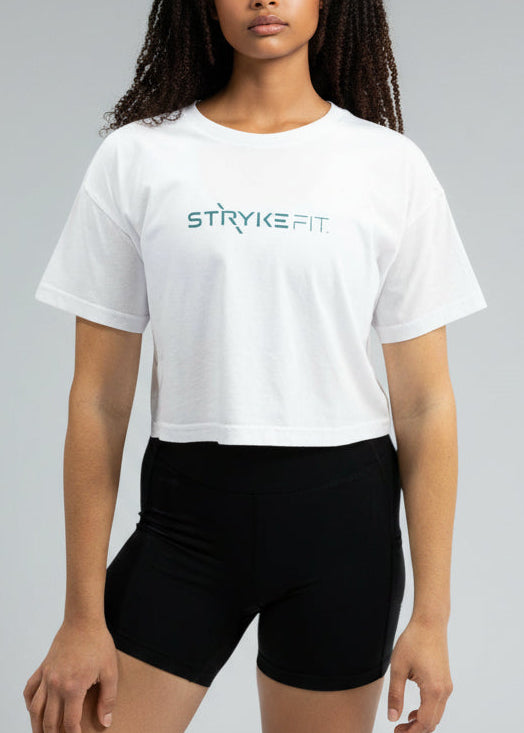 Woman wearing a white t-shirt and black shorts on a plain background
Your easy go to tee, done right.

The Focus Crop Tee is designed to pair effortlessly with all your Stryke activewear — perfect for gym sessions, or everyday wear.

Featuring a classic cropped silhouette and crafted from soft, breathable cotton, it delivers all-day comfort without feeling restrictive. Easy to style and even easier to wear, this is the piece you’ll reach for everytime.