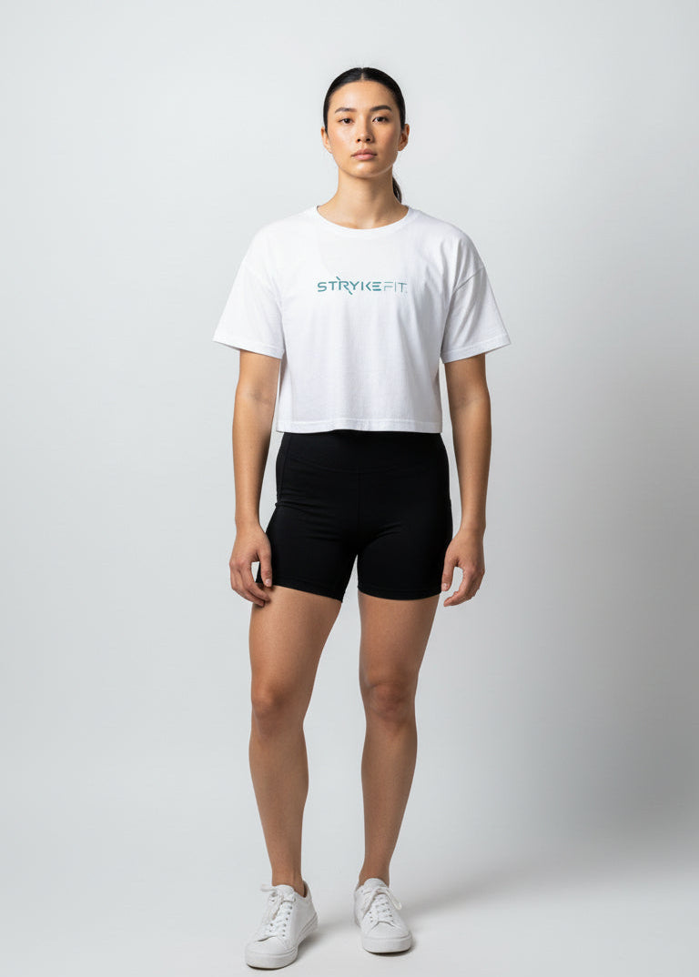 Woman wearing a white t-shirt and black shorts on a plain background
Your easy go to tee, done right.

The Focus Crop Tee is designed to pair effortlessly with all your Stryke activewear — perfect for gym sessions, or everyday wear.

Featuring a classic cropped silhouette and crafted from soft, breathable cotton, it delivers all-day comfort without feeling restrictive. Easy to style and even easier to wear, this is the piece you’ll reach for everytime.