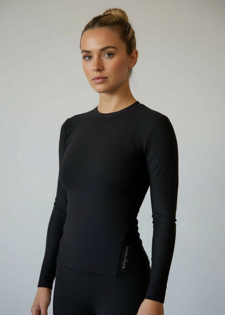 Woman wearing a black long-sleeve top against a gray background.
Engineered for movement, built for comfort — the IGNITE LS TOP is your go-to layer for any run. Whether you're warming up, or layering post-run, this is the perfect top

Made from ultra-soft, Nylon fabric, it offers just the right amount of warmth and support without sacrificing breathability.