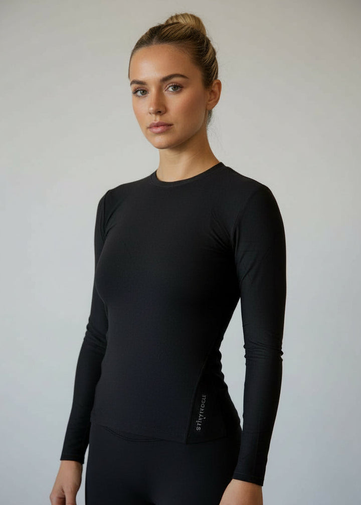 Woman wearing a black long-sleeve top against a gray background.
Engineered for movement, built for comfort — the IGNITE LS TOP is your go-to layer for any run. Whether you're warming up, or layering post-run, this is the perfect top

Made from ultra-soft, Nylon fabric, it offers just the right amount of warmth and support without sacrificing breathability.