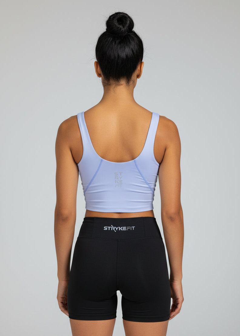 Woman wearing a light blue athletic outfit on a gray background.
The INTERVAL CROP TOP is a longer-length crop top with a built-in bra for extra support and added coverage. Designed for high-impact training this top is a great addition to any wardrobe.