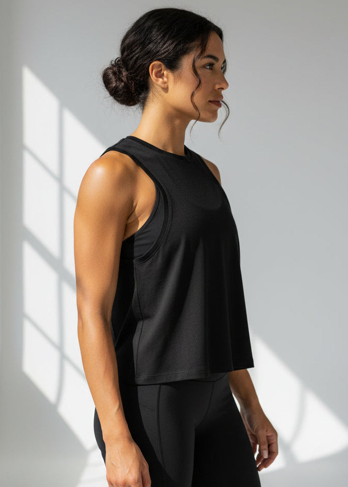 Woman wearing a black tank top and shorts with 'STRYKE FIT' logo on a light gray background.
The Jogging Singlet is made for runners who value comfort and consistency.

A dependable style you can throw on and trust for everyday runs, training sessions, and the miles in between.