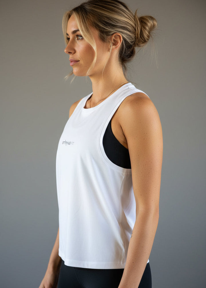 Woman wearing a black tank top and shorts with 'STRYKE FIT' logo on a light gray background.
The Jogging Singlet is made for runners who value comfort and consistency.

A dependable style you can throw on and trust for everyday runs, training sessions, and the miles in between.
