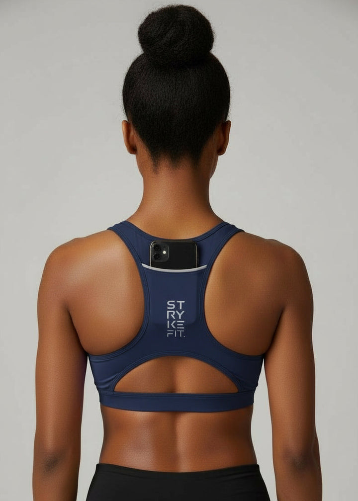 Built to move when you do.

The STRYKE Crop Top is engineered for runners who don’t want distractions — just performance.
Designed with a functional back pocket to carry your phone, gels or essentials on any run. The racerback design mirrors the natural movement of your shoulder blades, allowing unrestricted arm movement while delivering support where it counts.
