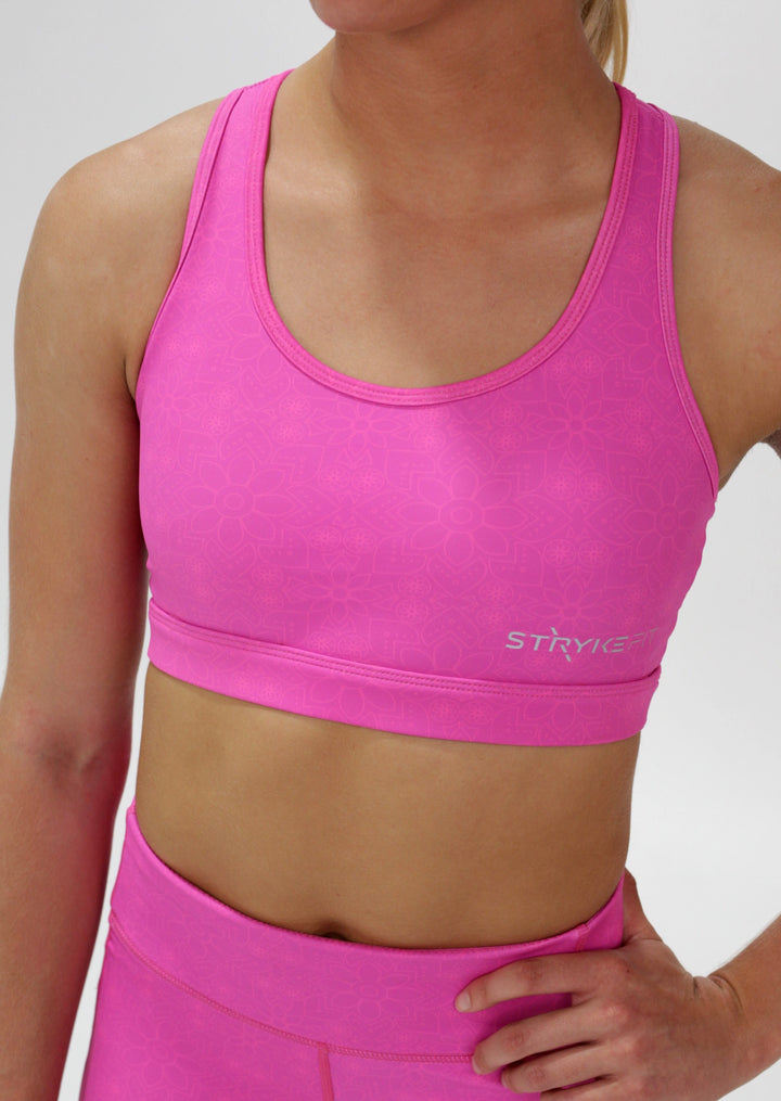 The STRYKE CROP TOP is designed with a back phone pocket enabling you to store your phone effortlessly while wearing, allowing you to listen to music, podcasts, or even just having your phone with you for personal security. The racerback straps follow the curve of your shoulder blades to allow your arms to move freely while offering maximum support. this Fuchsia pink Crop top with phone pocket is a must have this season.