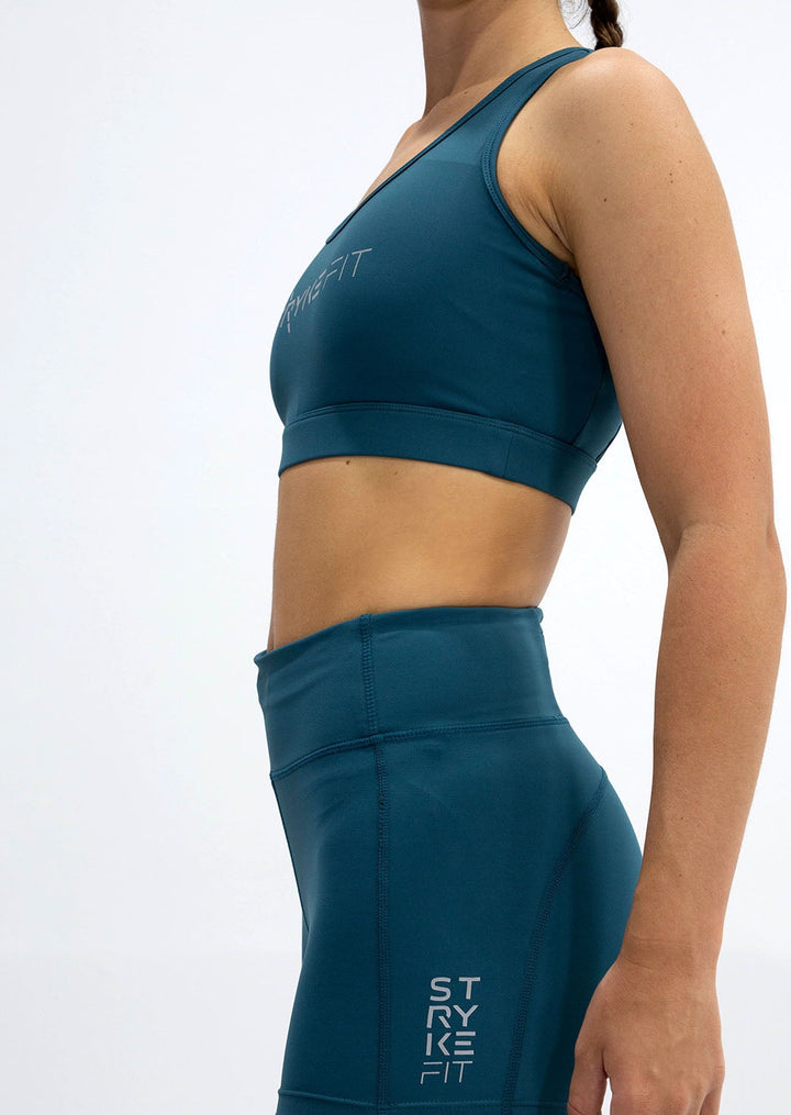 The STRYKE RUNNING CROP TOP is designed with a back phone pocket enabling you to carry your phone effortlessly while wearing, allowing you to listen to music, podcasts, or even just having it on you for personal security. The racerback straps follow the curve of your shoulder blades to allow your arms to move freely while offering maximum support. This running crop top is the perfect length for the perfect amount of support for a runner of all levels.