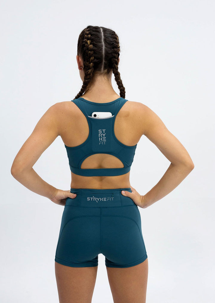 The STRYKE RUNNING CROP TOP is designed with a back phone pocket enabling you to carry your phone effortlessly while wearing, allowing you to listen to music, podcasts, or even just having it on you for personal security. The racerback straps follow the curve of your shoulder blades to allow your arms to move freely while offering maximum support. This shape of this running crop top compliments a runner's needs for the perfect supportive crop top.