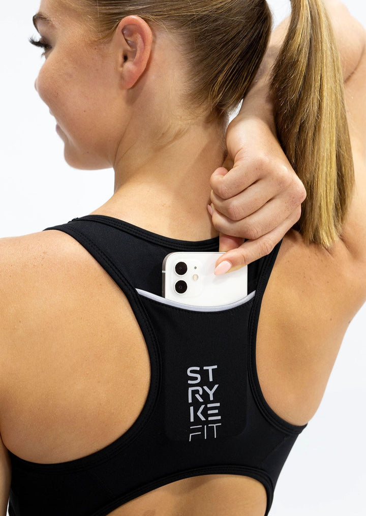 The STRYKE RUNNING CROP TOP is designed with a back phone pocket enabling you to carry your phone effortlessly while wearing, allowing you to listen to music, podcasts, or even just having it on you for personal security. The racerback straps follow the curve of your shoulder blades to allow your arms to move freely while offering maximum support.