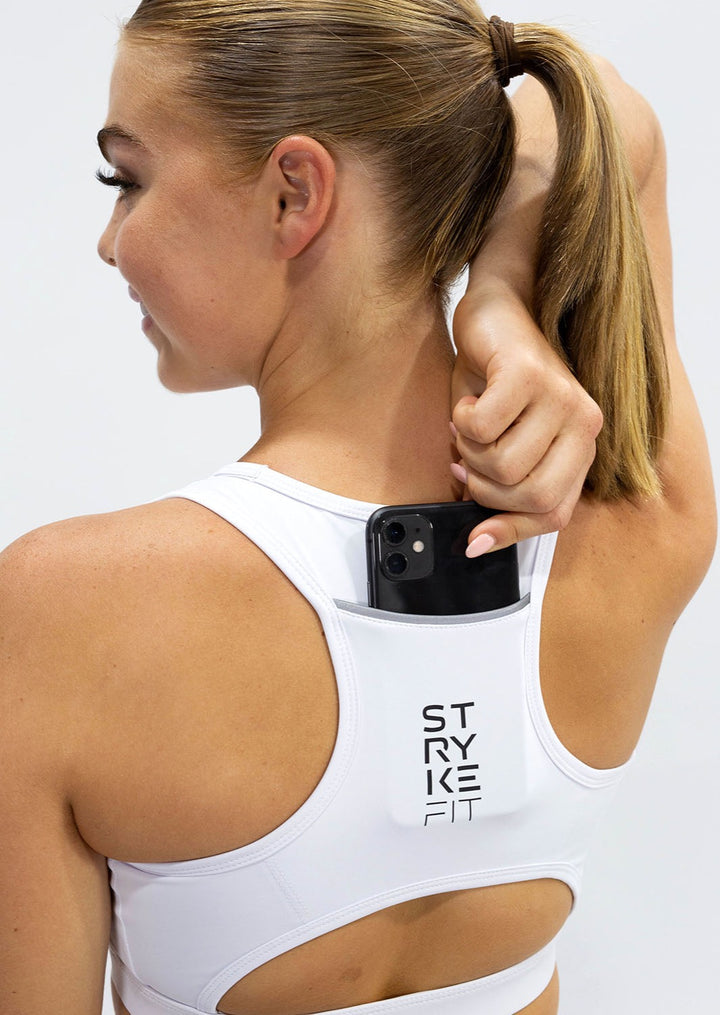 The STRYKE RUNNING CROP TOP is designed with a back phone pocket enabling you to carry your phone effortlessly while wearing, allowing you to listen to music, podcasts, or even just having it on you for personal security. The racerback straps follow the curve of your shoulder blades to allow your arms to move freely while offering maximum support. Once you start running with this crop top you won't be able to live without it.