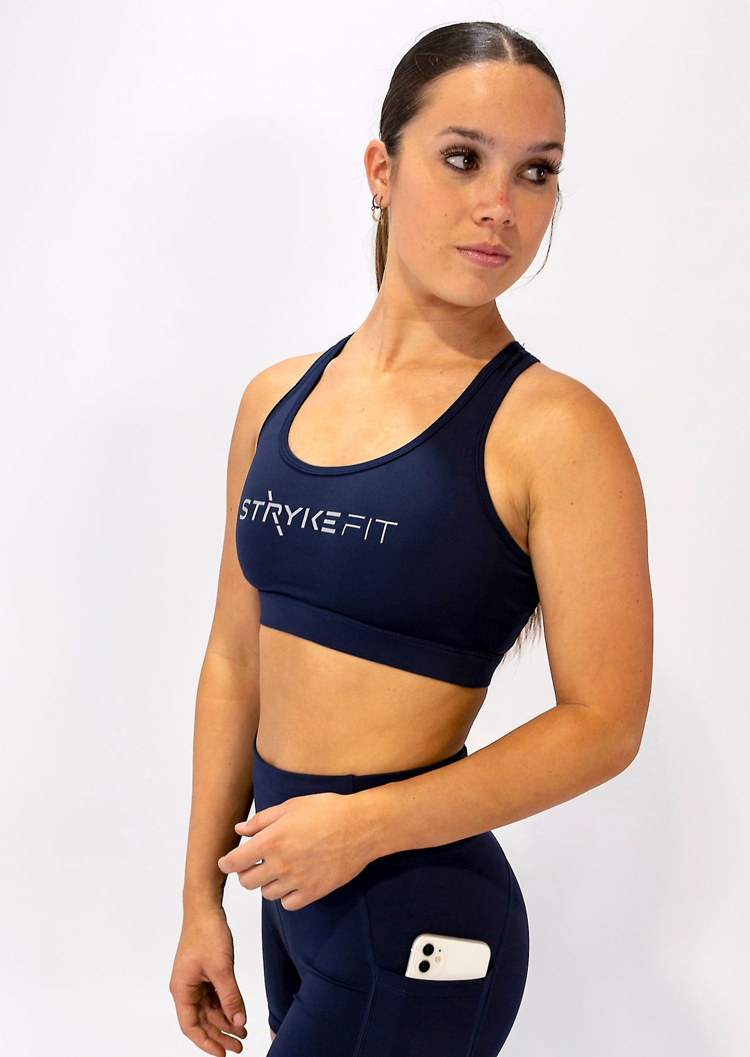 The STRYKE RUNNING CROP TOP is designed with a back phone pocket enabling you to carry your phone effortlessly while wearing, allowing you to listen to music, podcasts, or even just having it on you for personal security. The racerback straps follow the curve of your shoulder blades to allow your arms to move freely while offering maximum support. The reflective logo on the front chest and back help to enhance visibility in low light.